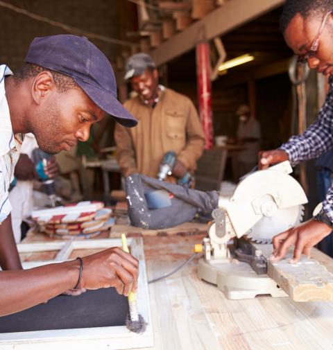 Three men at work in a carpentry workshop South Africa
