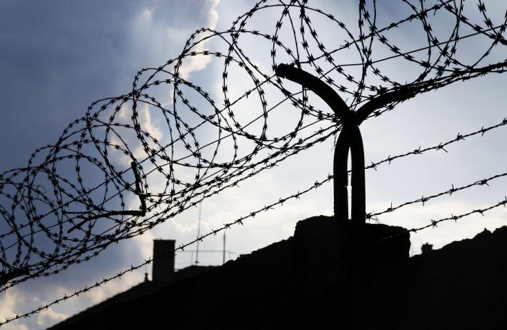 barbed wire on top of a fence, reflecting the theme of organised crime
