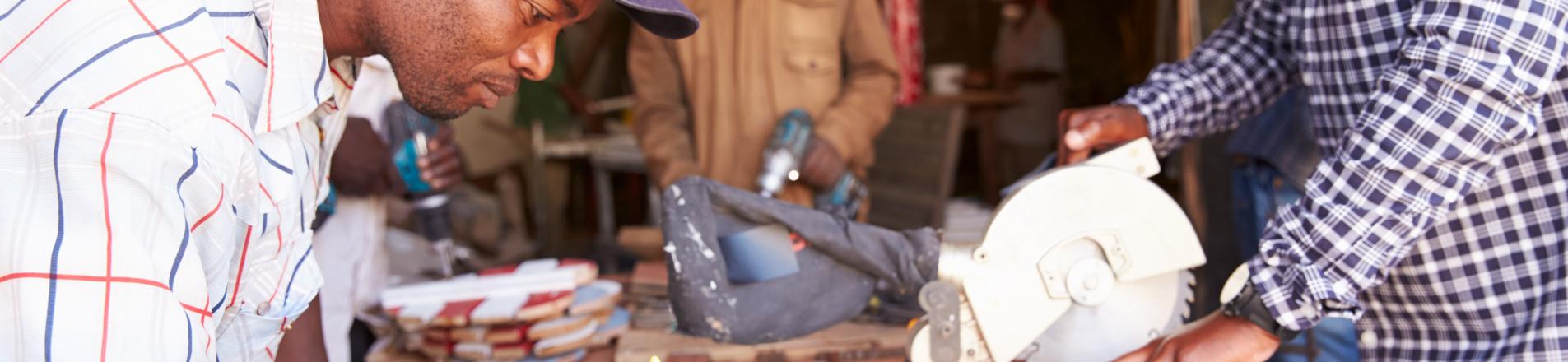 Three men at work in a carpentry workshop South Africa