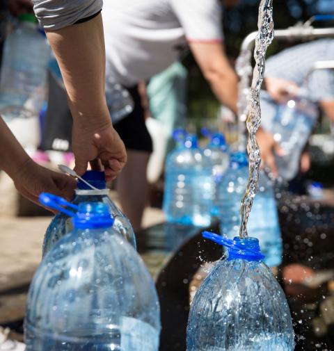 Photo of people filling up water bottles