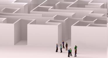 people entering a maze reflecting this podcasts theme of global economic uncertainty